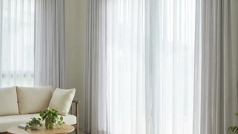 Sheer and grey curtains hanging in a bright Singapore living room